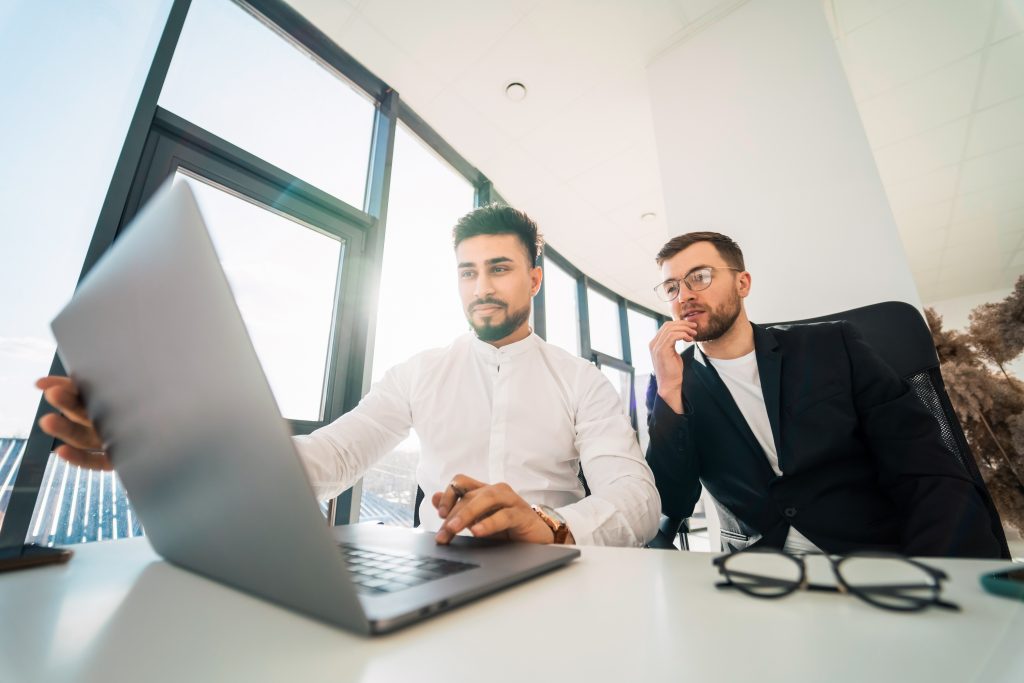 Two business partners are working on laptop