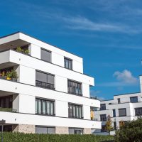 new white townhouses in front of a blue sky